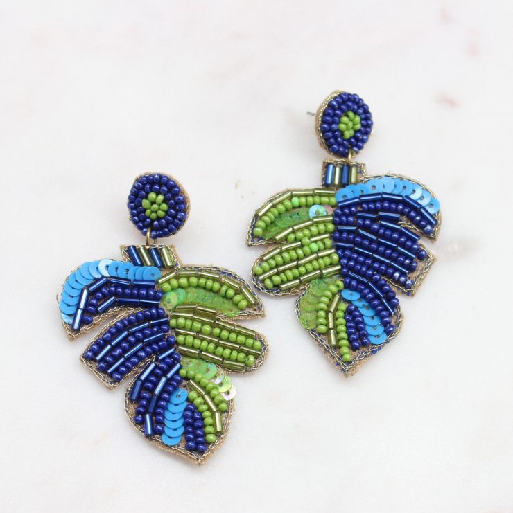 A photo of the Blue & Green Beaded Palm Earrings product