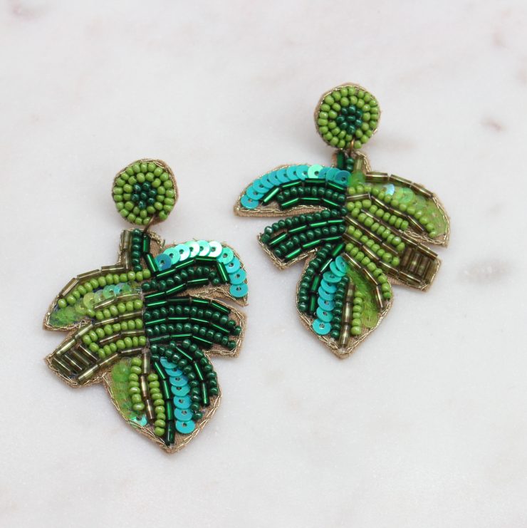 A photo of the Teal & Green Beaded Palm Earrings product