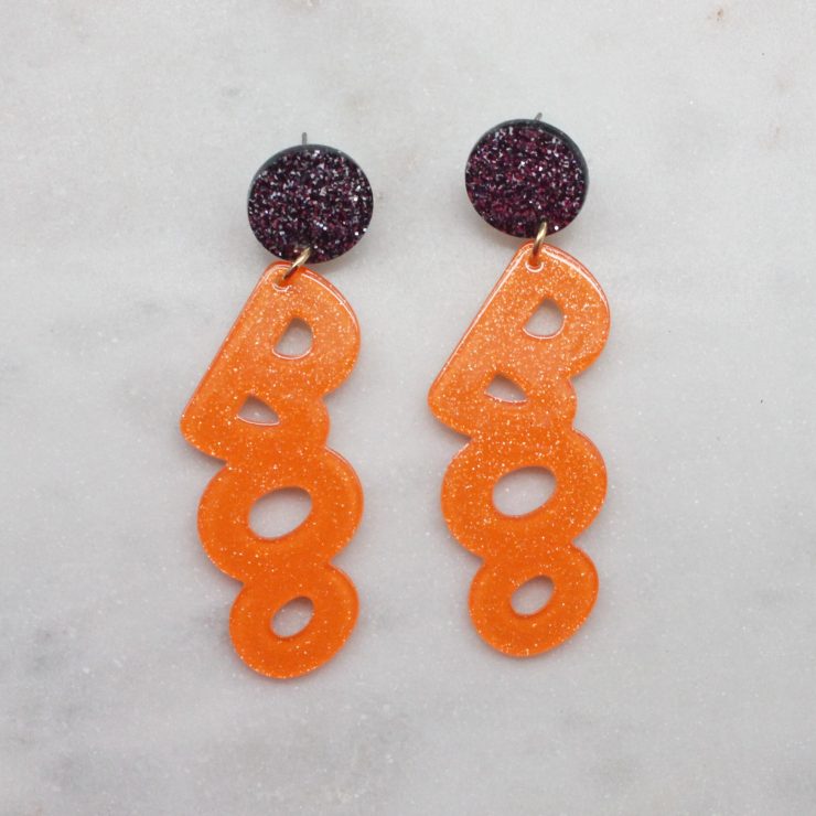 A photo of the BOO Earrings In Orange product