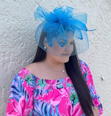 A photo of the Feather Fascinator In Neon Blue product