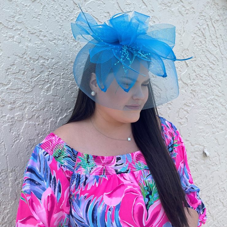 A photo of the Feather Fascinator In Neon Blue product