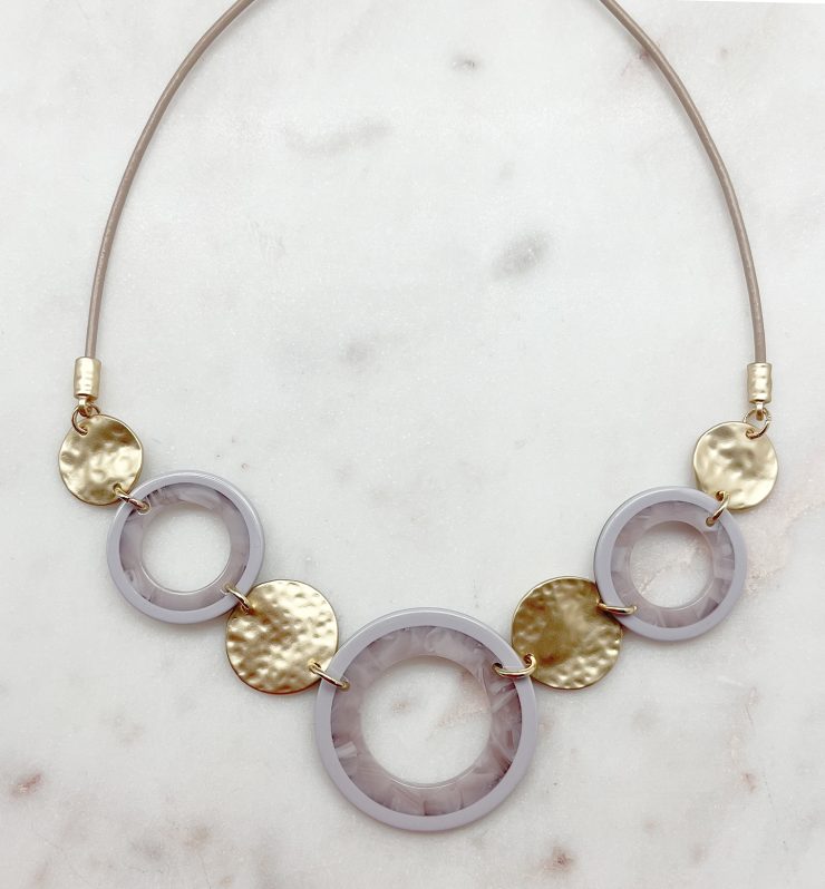 A photo of the Circle Around Necklace In Lilac product