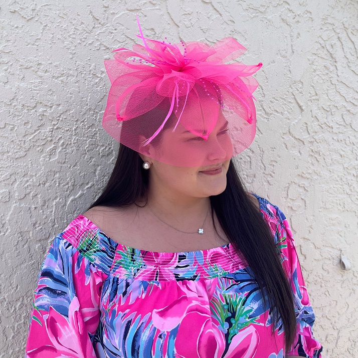 A photo of the Feather Fascinator In Neon Pink product