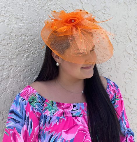 A photo of the Rose Fascinator In Orange product