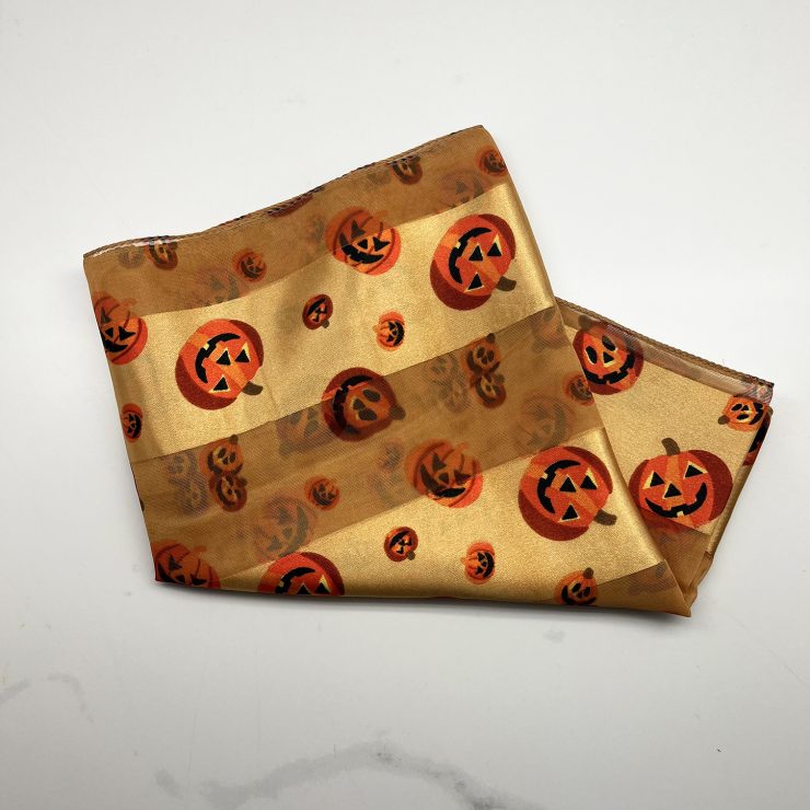 A photo of the Silky Jack-O-Lantern Scarf In Gold product