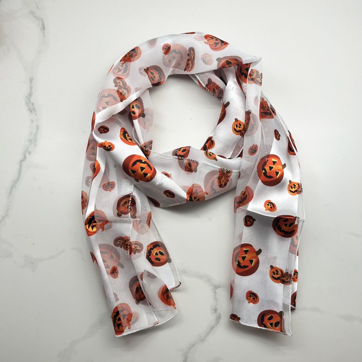 A photo of the Silky Jack-O-Lantern Scarf In White product