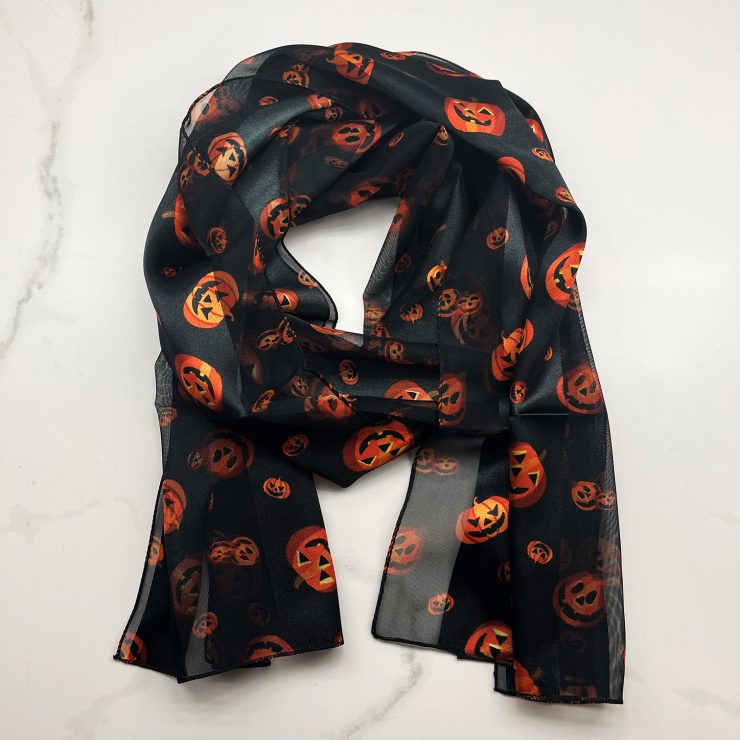 A photo of the Silky Jack-O-Lantern Scarf In Black product