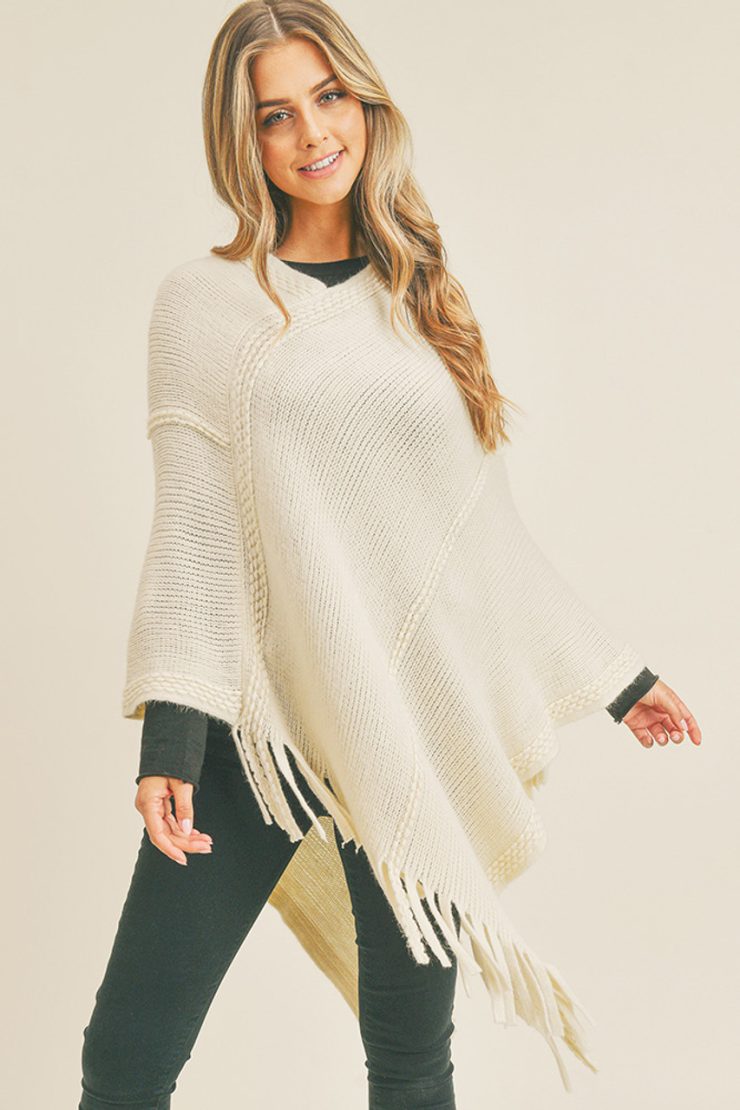 A photo of the Embossed Dotted Line Poncho In Ivory product