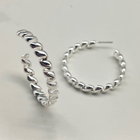 A photo of the Twisted Up Hoops In Silver product