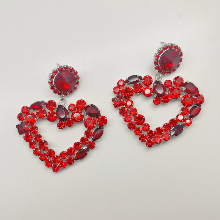 A photo of the Crystal Heart Earrings In Red product