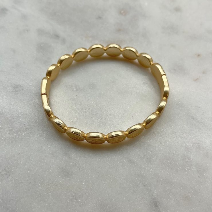 A photo of the Brushed Gold Pebble Bracelet product