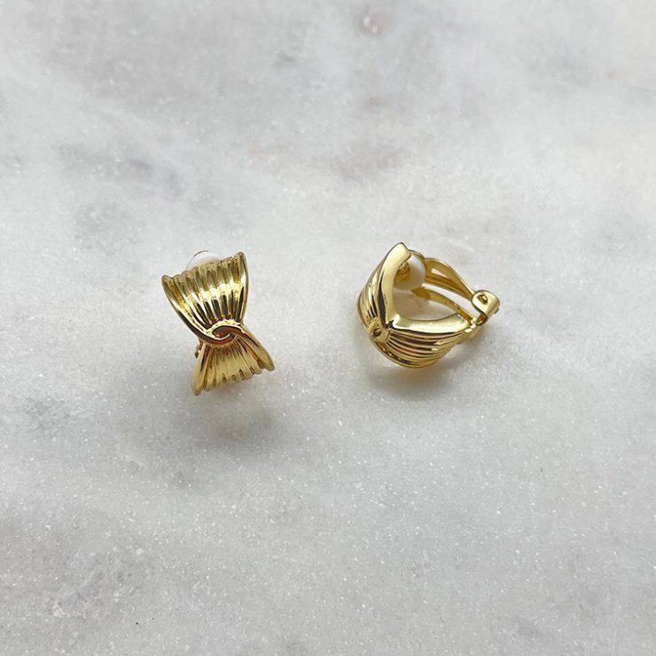 A photo of the Twisted Clip Earrings In Gold product
