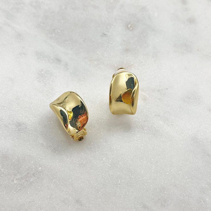 A photo of the Gold Wave Clip Earrings product