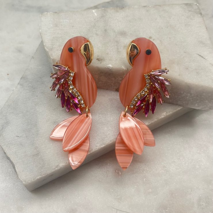 A photo of the Parrot Earrings In Pink product