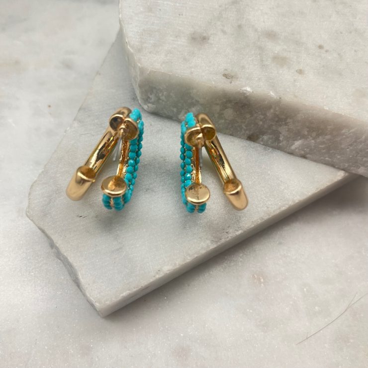 A photo of the Turquoise Double Hoops In Gold product