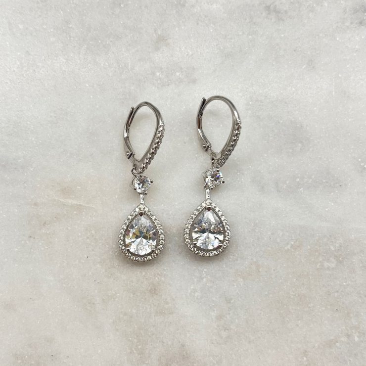 A photo of the Brilliance Rhinestone Drop Earrings product