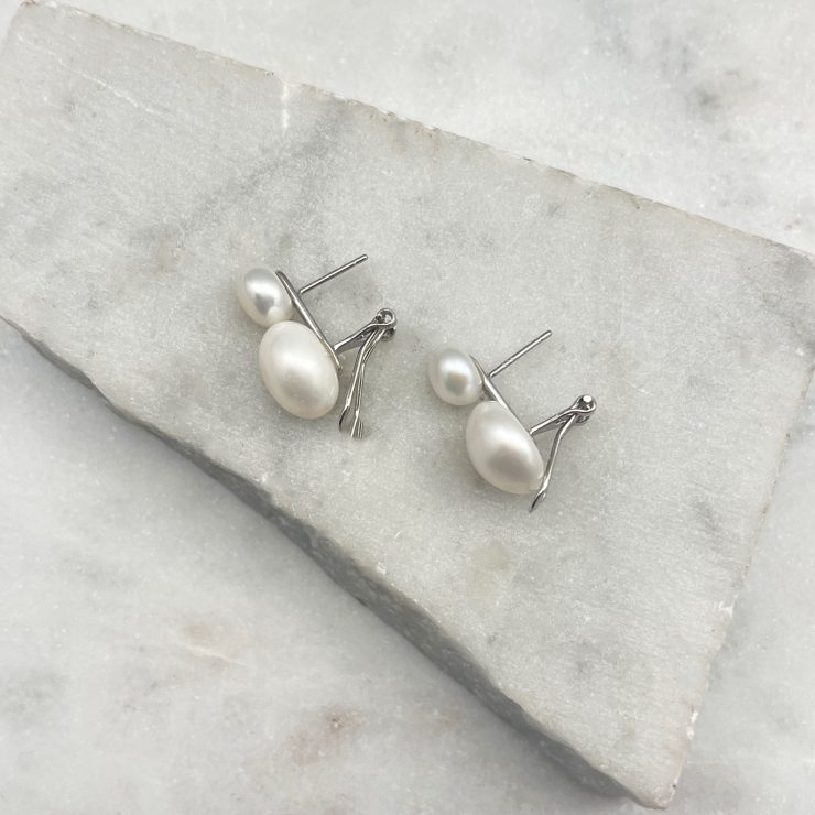 A photo of the Double Pearl Lever Back Earrings product