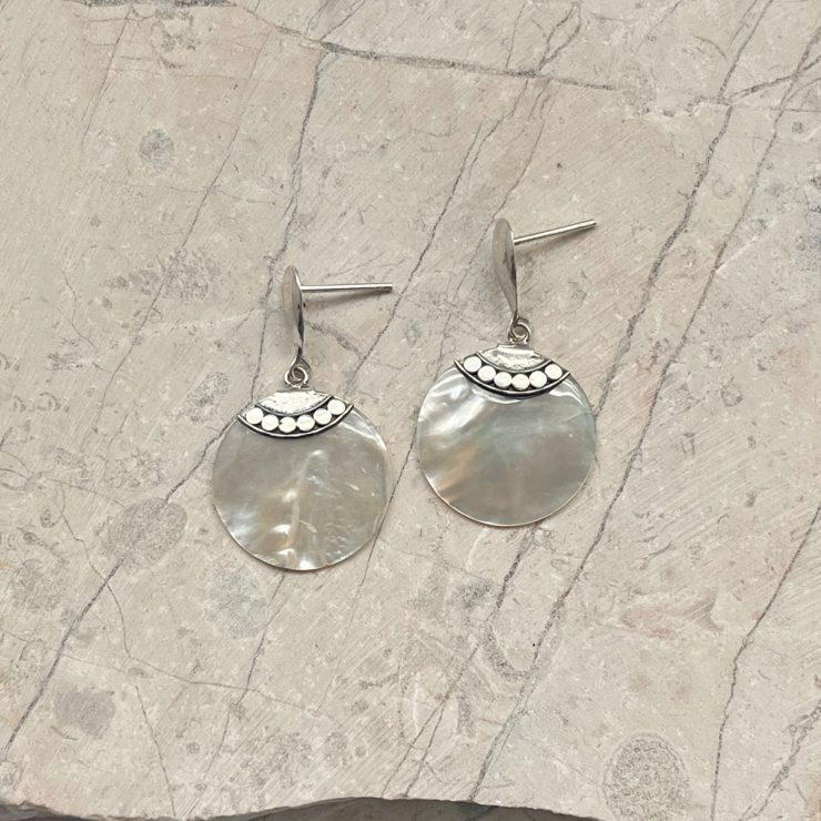 A photo of the Circle Mother of Pearl Earrings product