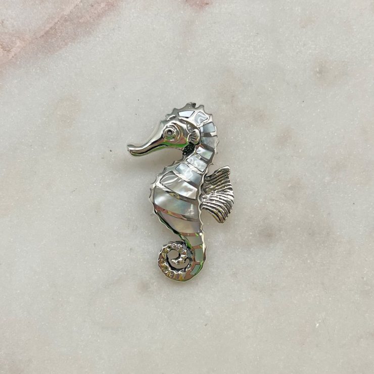 A photo of the Mother of Pearl Seahorse Pendant product