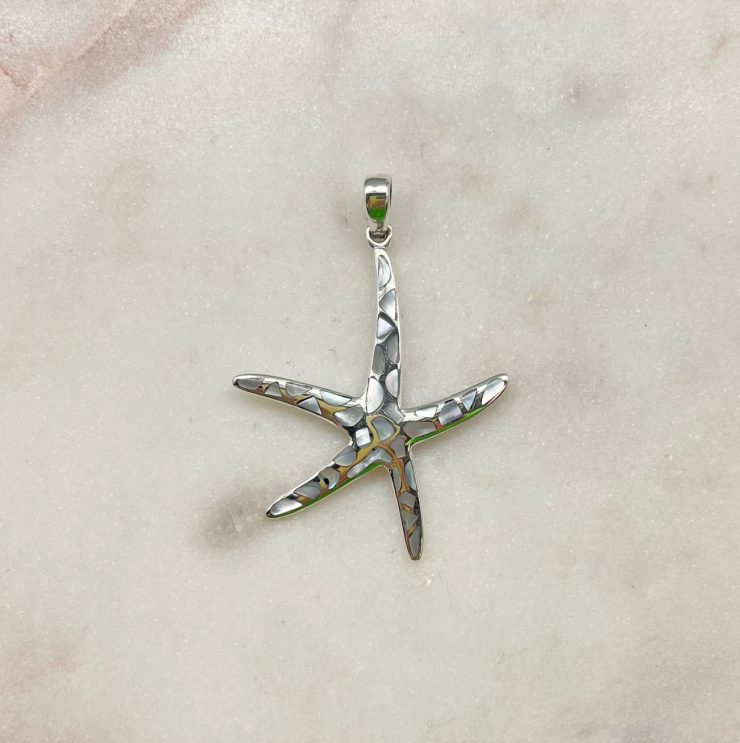 A photo of the Spotted Mother of Pearl Starfish Pendant product