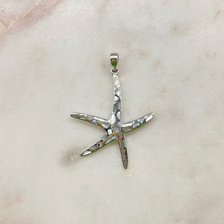 A photo of the Spotted Mother of Pearl Starfish Pendant product