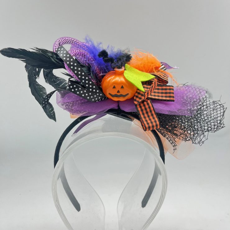 A photo of the Light Up Pumpkin Headband in Purple product