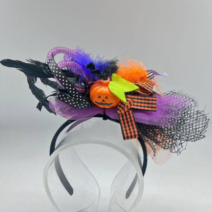 A photo of the Light Up Pumpkin Headband in Purple product