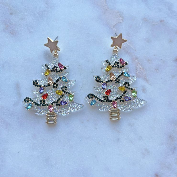 A photo of the Glitzy Christmas Tree Earrings in White Glitter product
