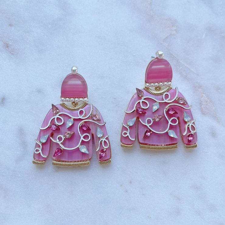 A photo of the Pink Christmas Sweater Earrings product