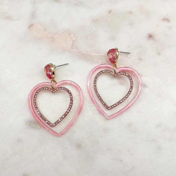 A photo of the Loving Hearts Earrings in Pink product