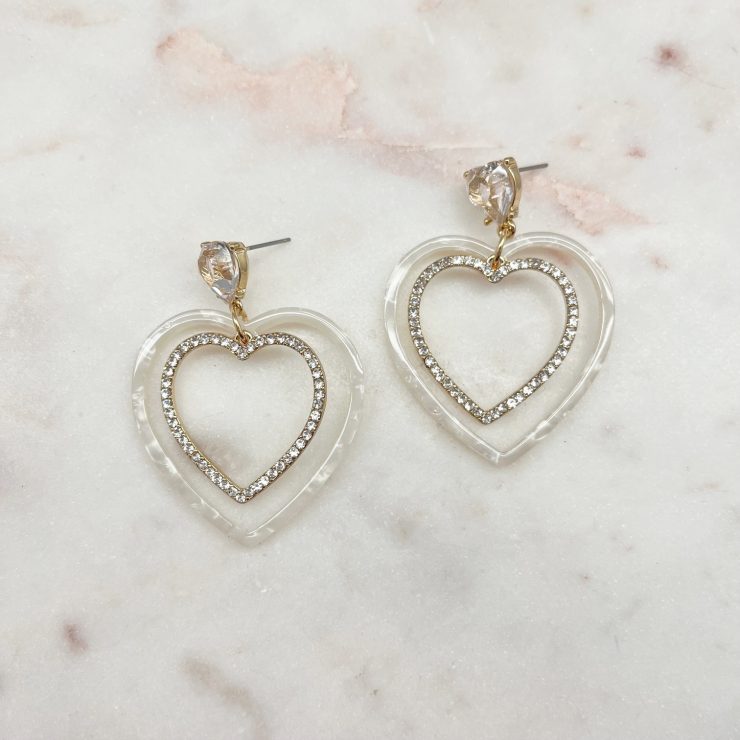A photo of the Loving Hearts Earrings in White product
