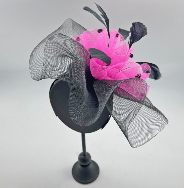 A photo of the Nita Fascinator in Black & Pink product