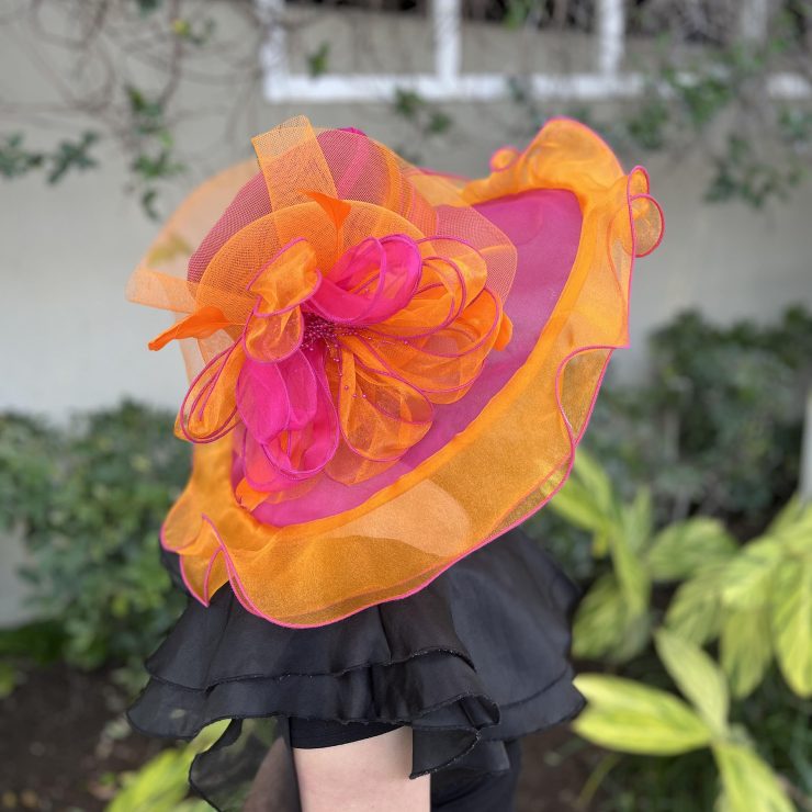 A photo of the Nora Fascinator Hat in Orange & Hot Pink product