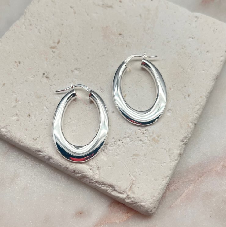 A photo of the Italian Sterling Silver Small Flat Oval Hoops product