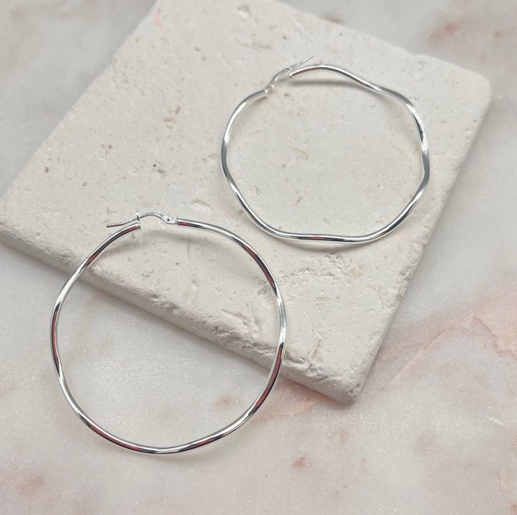 A photo of the Italian Sterling Silver Wide Wave Hoops product