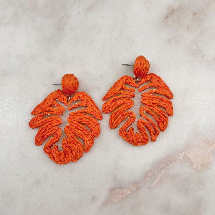 A photo of the Tropical Leaf Earrings in Orange product